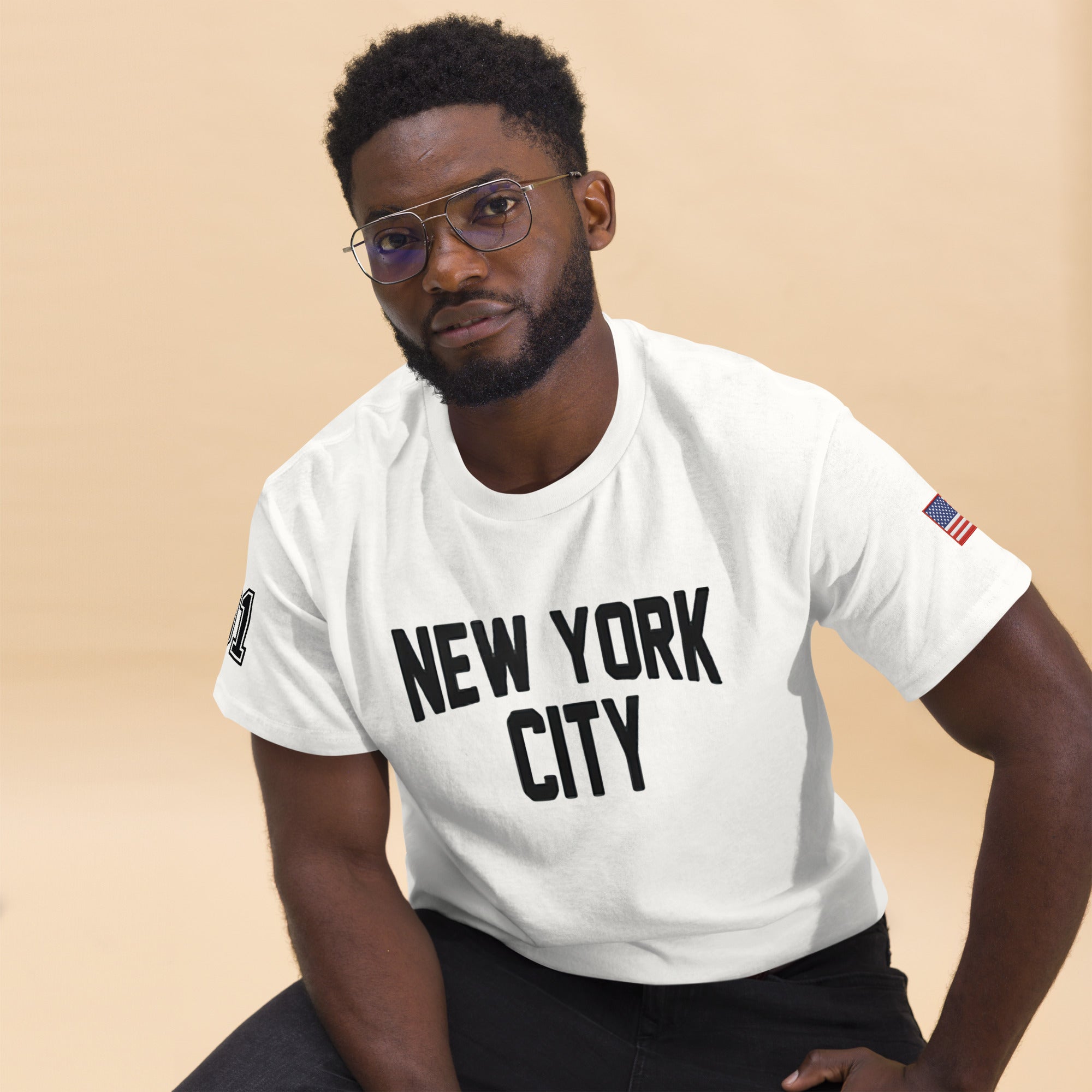 Man wearing a white t-shirt with 'New York City' text on a beige background